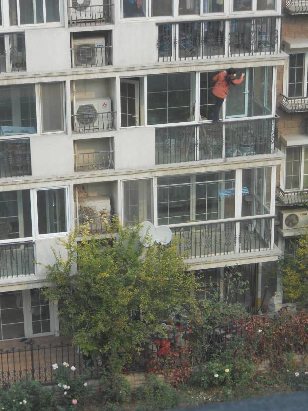 Here is a woman in our complex cleaning her windows